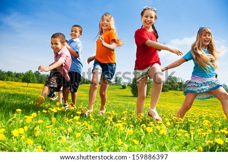 Five happy diversity looking children running in the park Royalty-Free Stock Photo #159886397