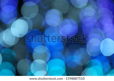 Abstract blurred background. Blurry lights. Blurry garland with blue lights. blue toning. Christmas coming concept.