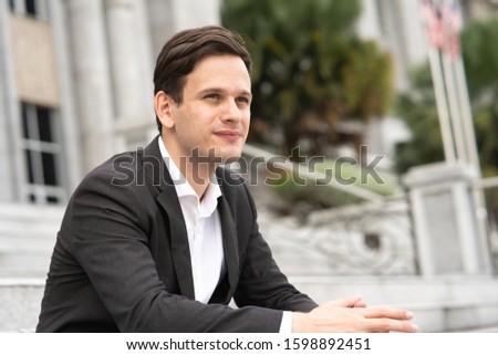 Businessman sit at office staircase.