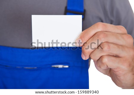Portrait Of Happy Mechanic In Workwear Holding Visiting Card