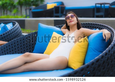 Portrait beautiful young asian women happy smile relax around outdoor swimming pool in hotel resort for travel vacation