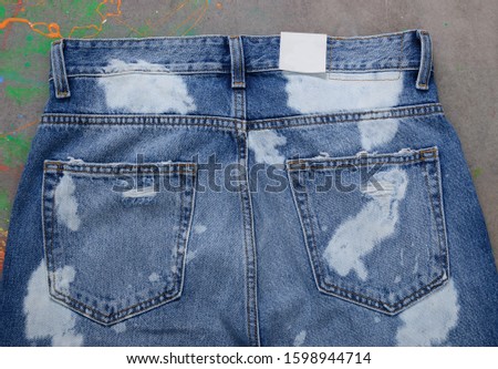 blue and white Jeans denim texture- back view pocket close up splash ink gray background
