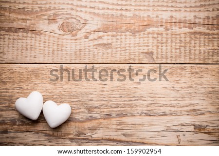 White heart and wooden  background.