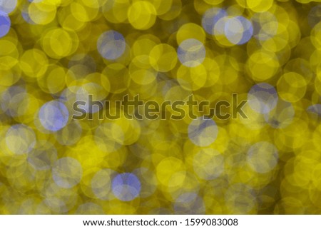 Defocused photography of colorful Christmas lights in night. Impressionism style. Twinkle of white, gold and blue lights. Suitable as background for miracle creative template