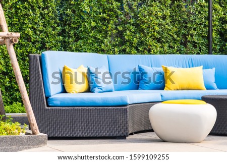 Outdoor patio in the garden with sofa chair and pillow decoration for take a relax