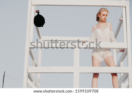Portrait of a woman in underwear on a beach near the ocean
