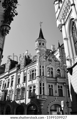 Beautiful medieval building with tower. Sunny day in the Old Town of Riga, Latvia. Vertical view, black and white photo