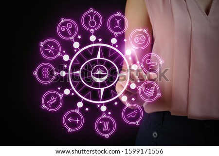 Astrological signs and young woman on dark background