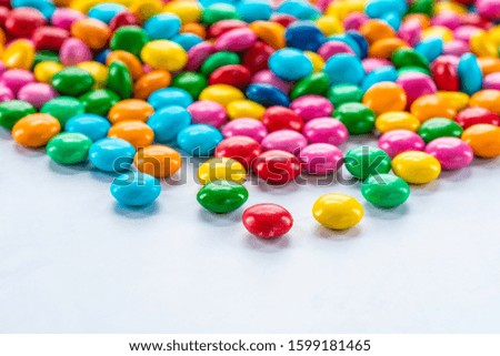 Colorful candy sweets on white background - closeup with selective focus.