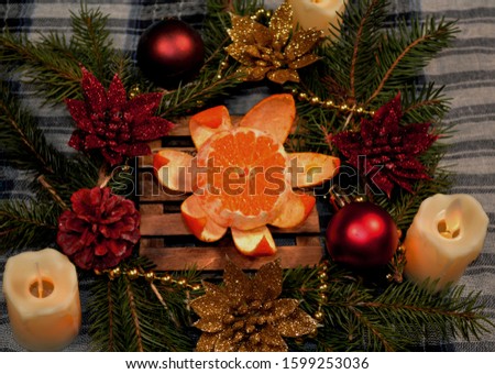cozy background, beautiful festive still life, New Year decoration with candles tangerines ...