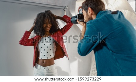 Behind the Scenes on Photo Shoot: Beautiful Black Model Posing for a Photographer, he Takes Photos with Professional Camera. Stylish Fashion Magazine Photoshoot done with Pro Equipment in a Studio