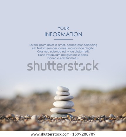Zen pyramid of spa stones on the blurred sea background. Sand on a beach. Sea shores. Web article template. Long header banner format. Sale coupon. Visit card. Your information. Text space.