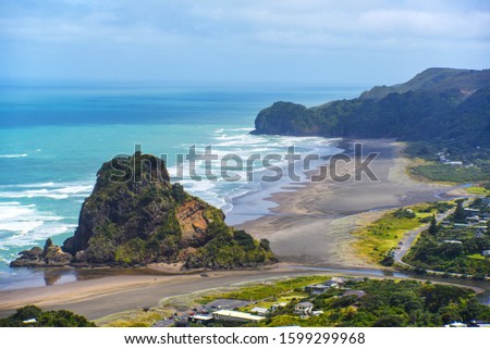 view of the black volcanic sand beach popular with surfers. Piha beach near Auckland. New Zealand. Selective focus