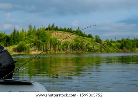 Perfect fishing time: deep lake, beautiful sky, forest on the banks