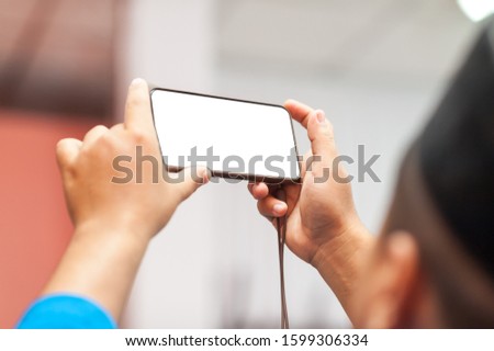 Young Asian Muslims use a mobile phone to take pictures surprisingly during the event that is happening Happily to pass on happiness to friends who communicate in the social world to know