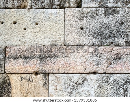 Detail of an ancient stone wall of the Acropolis, Athens, Attica region in Greece. Close-up of huge antique blocks of stone forming a wall. Photo.