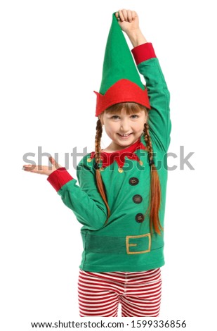 Little girl in costume of elf showing something on white background
