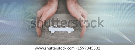Hands protecting a car; symbol of car insurance; panoramic banner
