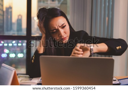 Emotion towards working in the office : Blur image Business women sit and look at their watch, worried about boring overtime in the office : Blur background
 Royalty-Free Stock Photo #1599360454