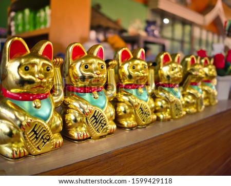 Row of Japanese Lucky Cat or Maneki Neko, Japanese and Chinese Golden Cat dools brings good luck.