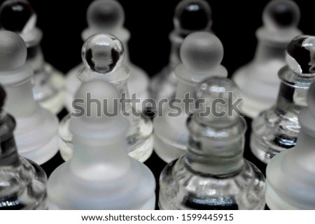 Classic glass chess pieces.Photo on a black background.