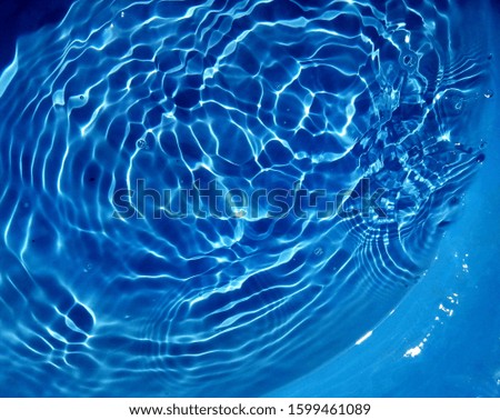 The sunlight reflected with surface waves of blue water in the deep sea