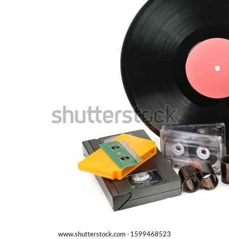 Vinyl record, video and audio cassettes isolated on white background. Retro equipment. Free space for text.