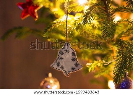 Wooden toy on a Christmas tree. Wooden bell
