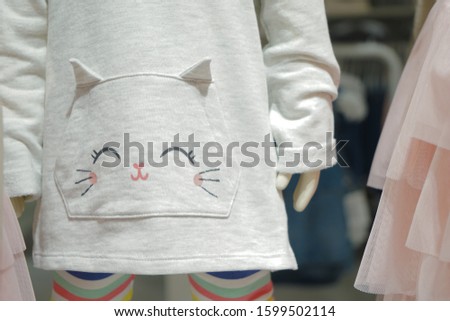 kitty cartoon on the baby light gray sweater.
