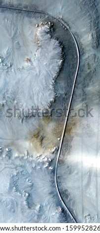 the long and winding road, vertical abstract photography of the deserts of Africa from the air, aerial view of desert landscapes, Genre: Abstract Naturalism, from the abstract to the figurative, 