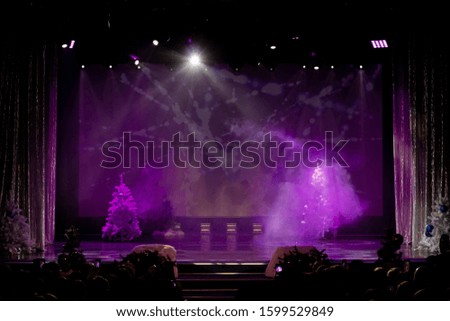 A theater stage with a curtain illuminated by stage light and smoke. Texture background for design.