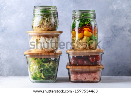 Glass boxes and cans with fresh food refrigerator storage concept decanting Royalty-Free Stock Photo #1599534463
