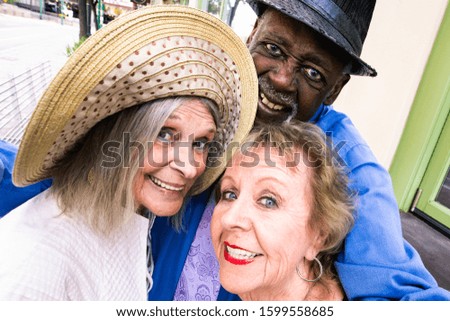 Three seniors downtown taking a selfie