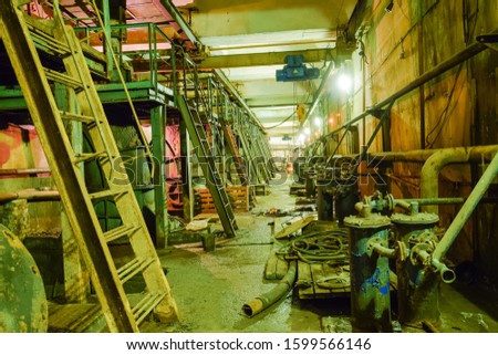Basement of a water pumping station. Abandoned post-apocalyptic view of the basement pumping rooms.