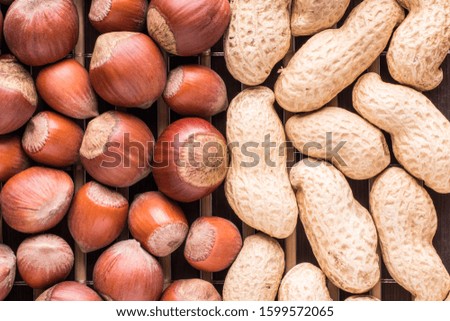 Natural background from assorted nuts. Hazelnuts and peanut in shell