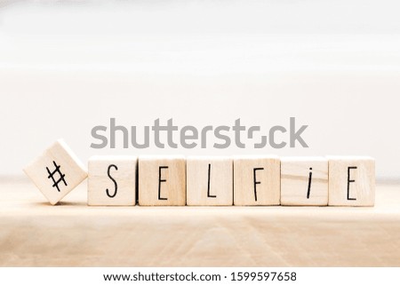 Wooden cubes with a Hashtag and the word selfie background, Social media concept close-up