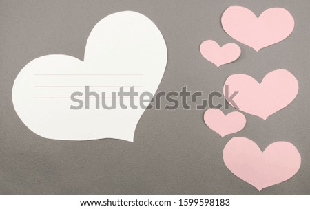 Colorful paper hearts with note for greeting card