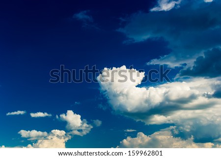 Sunny blue sky with puffy clouds