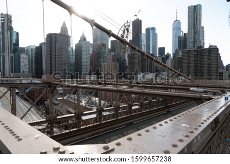 New York City Skyline From The Steel Beams Of The Brooklyn Bridge.