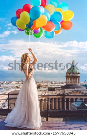 Girl, fashion model with balloons on the background of St. Petersburg, Russia. Kazan Cathedral