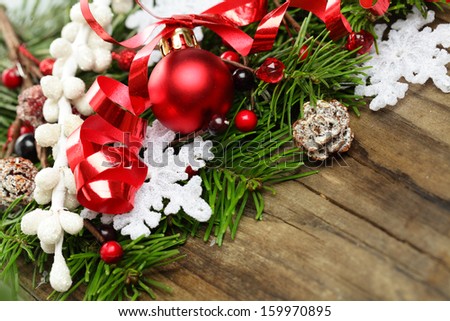 Christmas ball, snowflake and decoration over wooden background