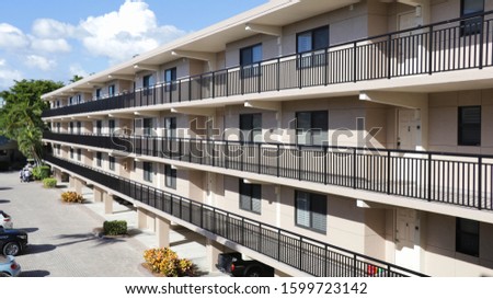 Aesthetic picture of a three story hotel building. Royalty-Free Stock Photo #1599723142