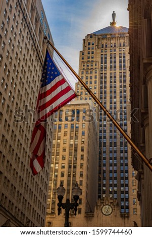 An inspiring morning on LaSalle Street in the American city of Chicago, with the flag of the United States of America hanging and shining with the first rays of the sun that make us proud of this land
