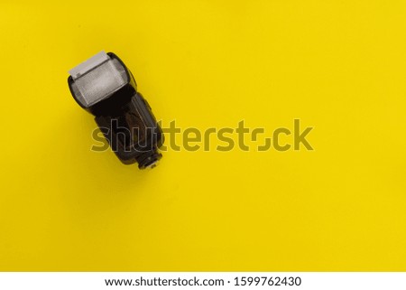 Hand flash on yellow background. lighting concept of photo scenes