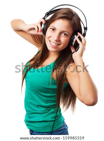 young woman listening to music with headphones isolated on white