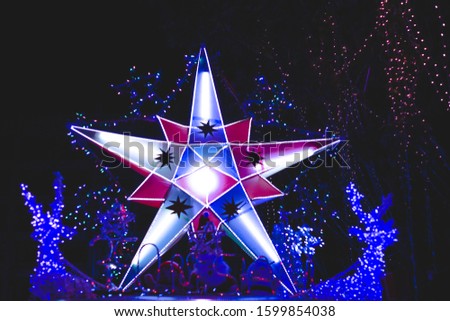 Taking photo of lighting decoration star shaped in front of office building for upcoming New Year ceremony on holiday.