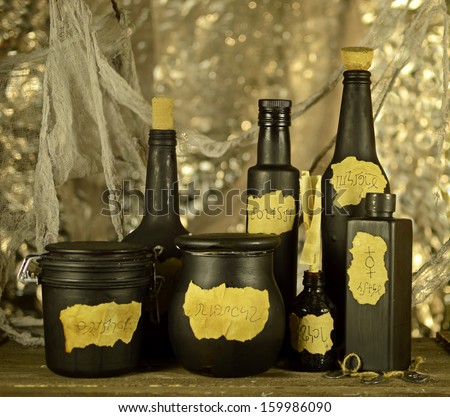 Black witch bottles on blurred background