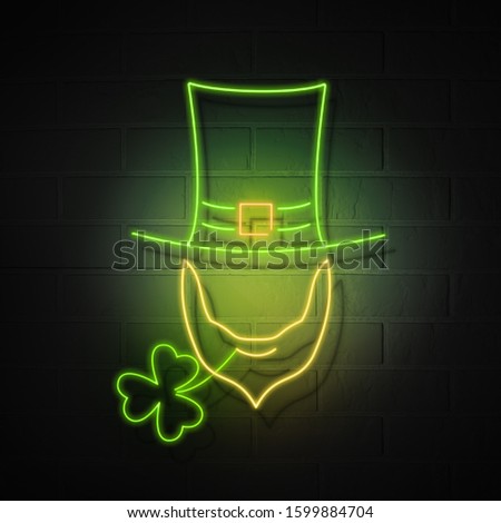 A hat with a beard without a face and a shamrock of clover. Glowing neon symbols of the holiday of St. Patrick on the background of a brick wall.