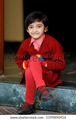 Indian little girl in school uniform and showing expression 