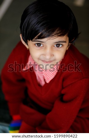 Indian little girl in school uniform and showing expression 